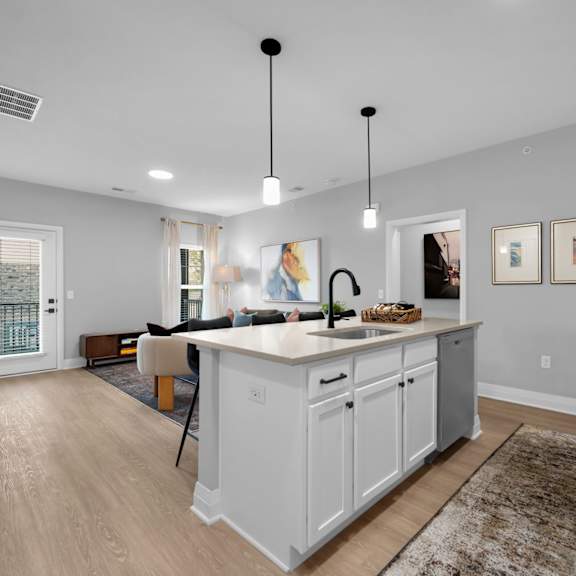 a kitchen with white cabinets and a large island.