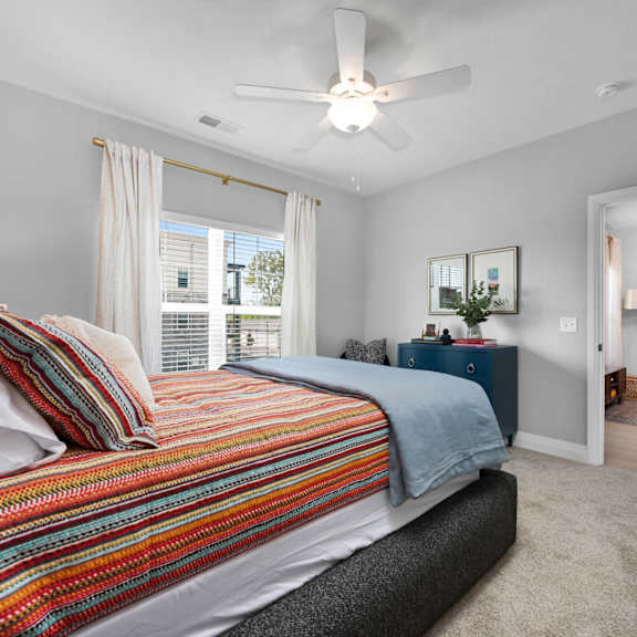 a bedroom with a bed, a dresser, and a mirror.