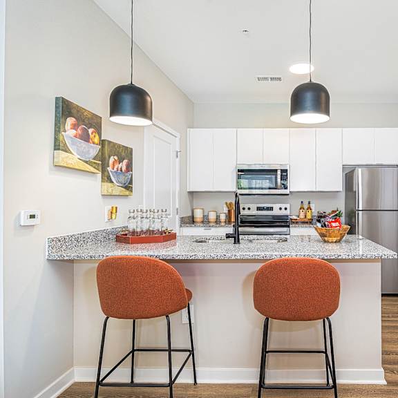 a kitchen with a granite counter top and two stools