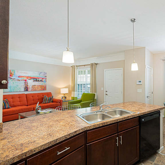 an open kitchen and living room with a dining room table and chairs
