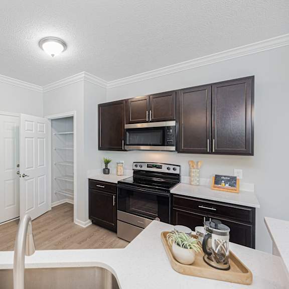 a kitchen with black appliances and brown cabinets