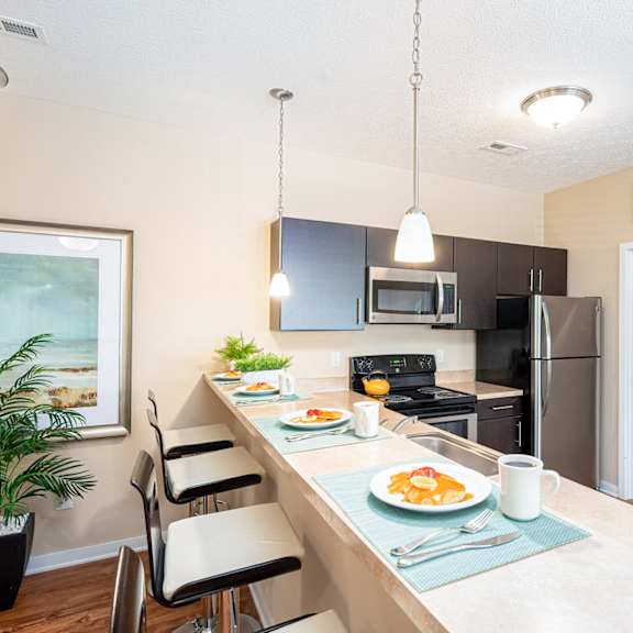 a kitchen with a long counter with plates of food
