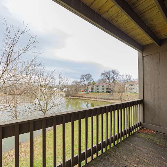 a balcony with a view of a river and buildings.