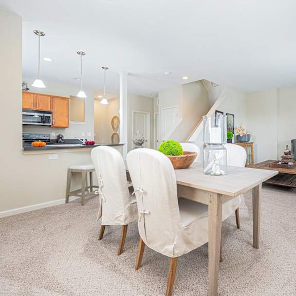 a dining room with a table and chairs.