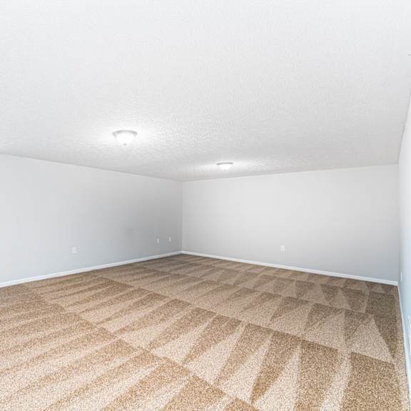 a room with a carpeted floor and white walls.