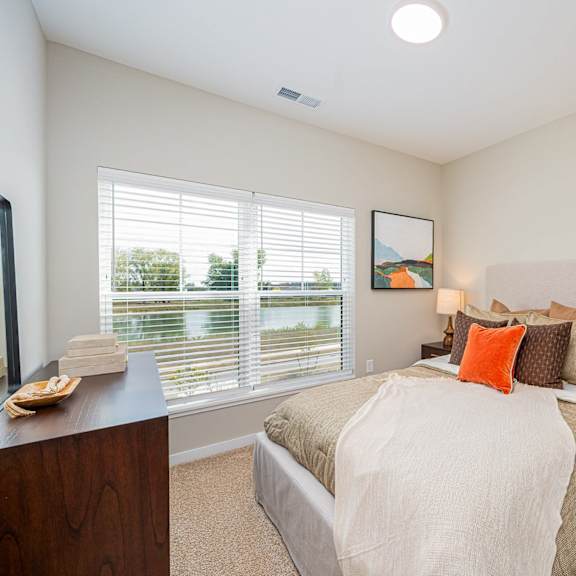 a bedroom with a large bed and a window