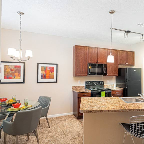 an open kitchen and dining area with a granite counter top