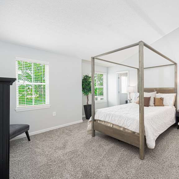 a bedroom with a four poster bed