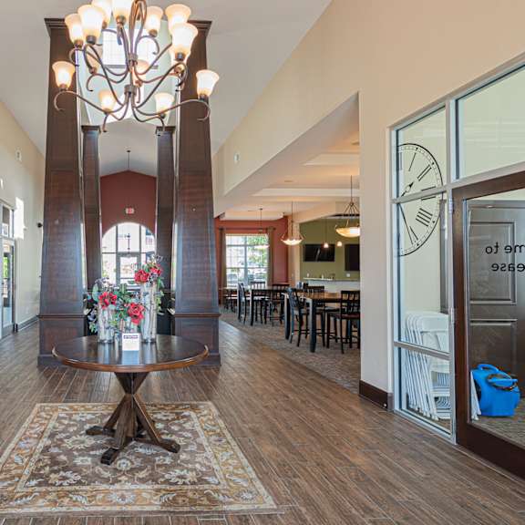 a large lobby with a table and a chandelier