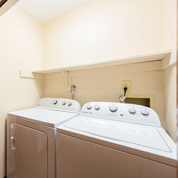 a washer and dryer in a laundry room with a door