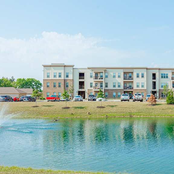 an image of an apartment building overlooking a lake