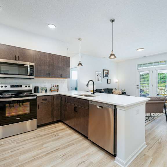 a large kitchen with wooden cabinets and stainless steel appliances