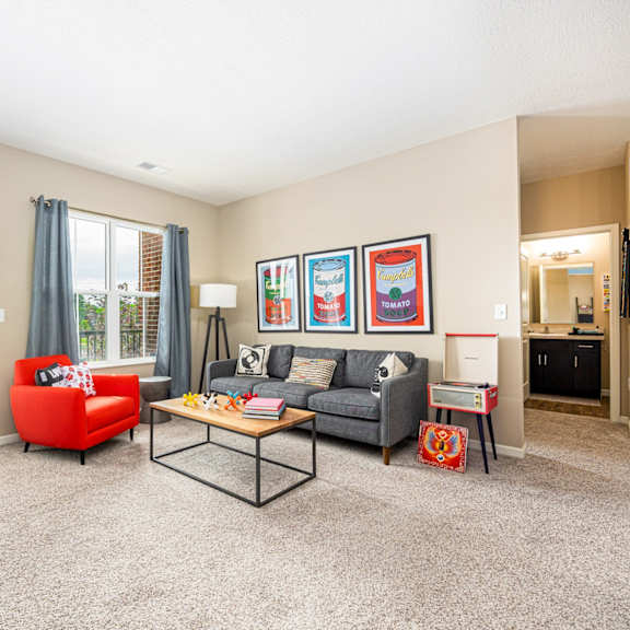 the living room of our apartments with a couch and a chair