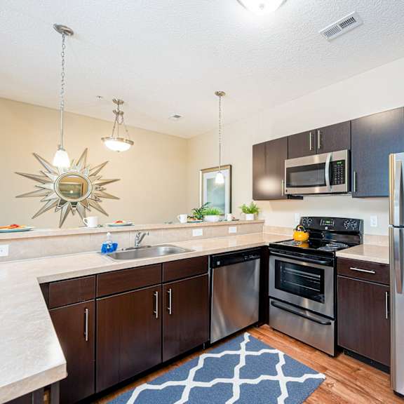 full kitchen with stainless steel appliances at the reserve at walnut creek apartments