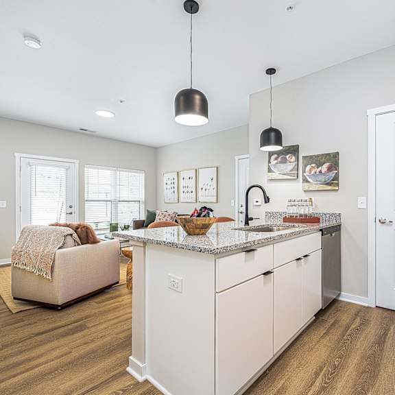 a kitchen with an island and a living room with a couch