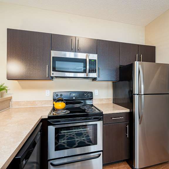 a kitchen with stainless steel appliances and a stainless steel refrigerator