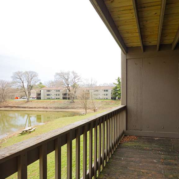 a balcony with a glass door leading to a room.