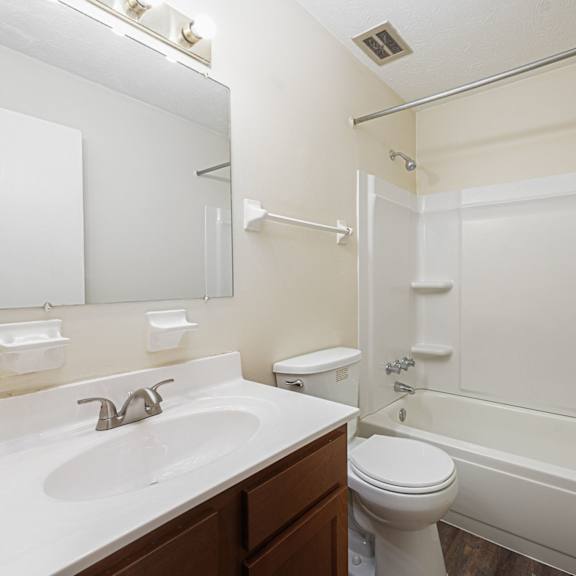 a bathroom with a sink toilet and a bath tub
