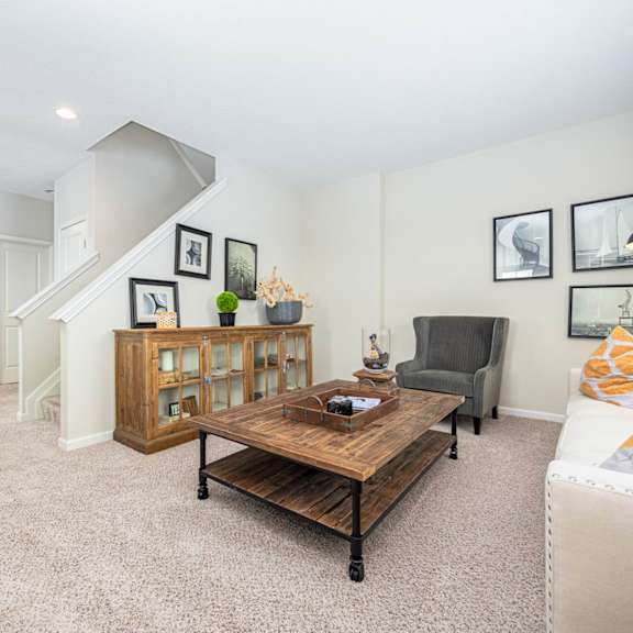 a living room with a couch, coffee table, and pictures on the wall.