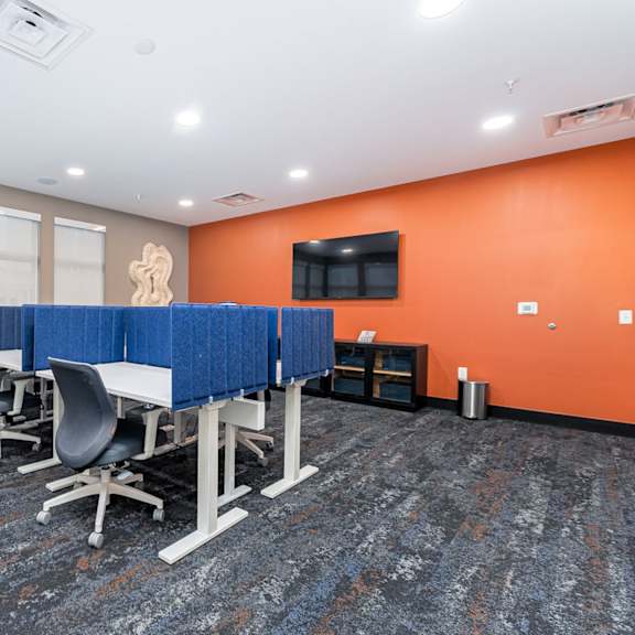 a conference room with blue dividers and chairs.