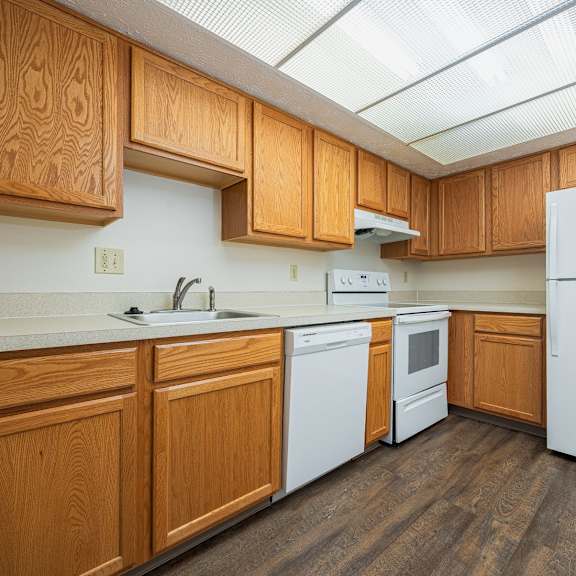 a kitchen with wooden cabinets and a white refrigerator.