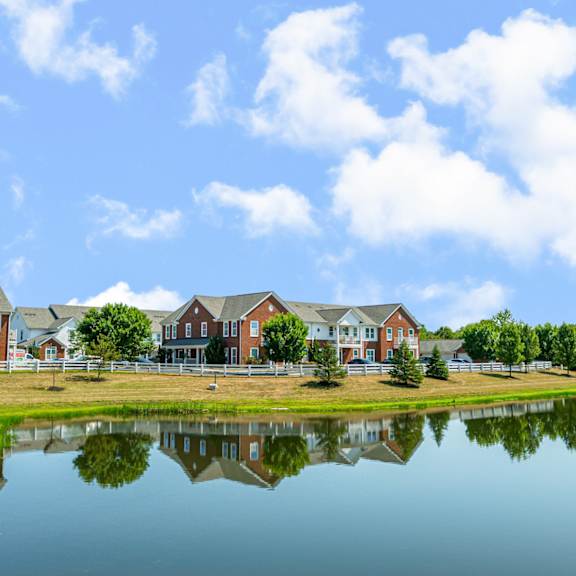 the view of a building reflected in a pond