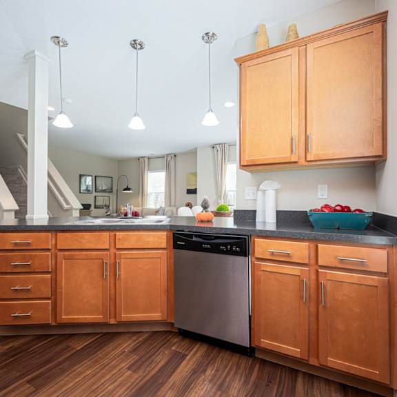a kitchen with wooden cabinets and a black countertop.