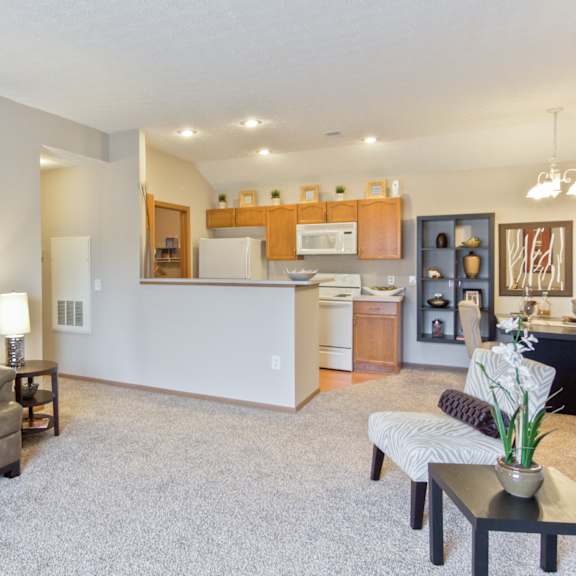 a living room and kitchen with a couch and a table