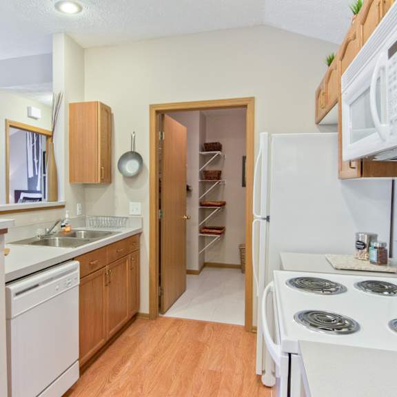 a kitchen with a stove and a refrigerator and a sink