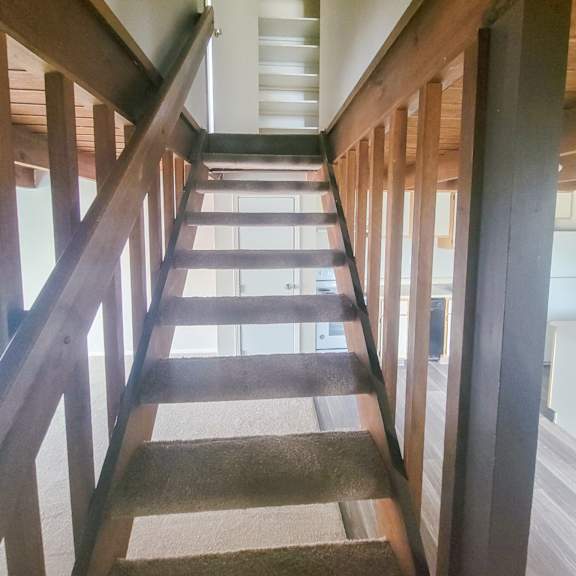 looking down the stairs from the second floor