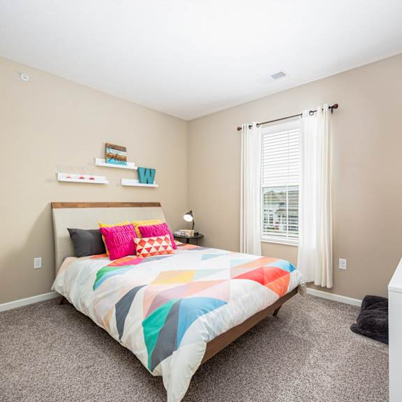 a bedroom with a bed and a window