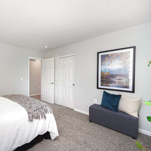 a bedroom with a bed and a couch