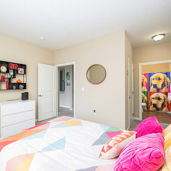 a bedroom with a bed and a door to a closet