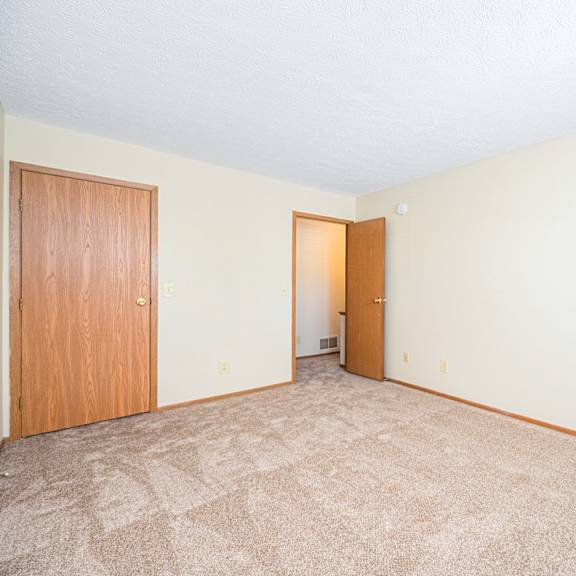 a hallway with white walls and a geometric pattern on the floor