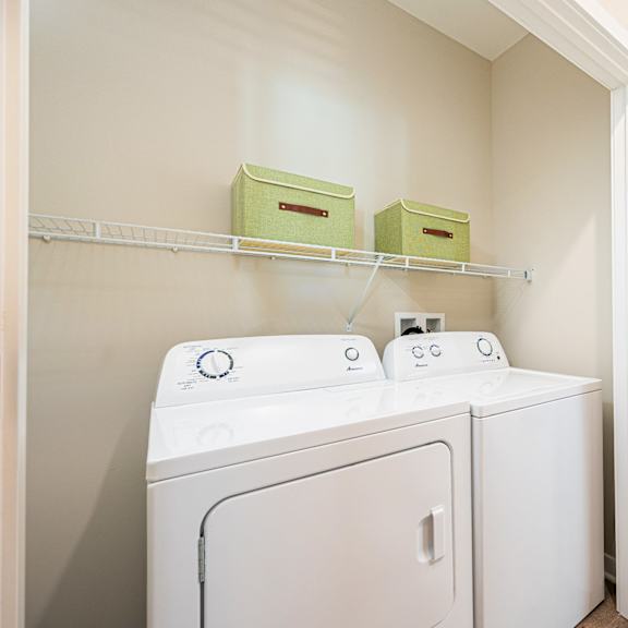 a washer and dryer in a laundry room with a closet