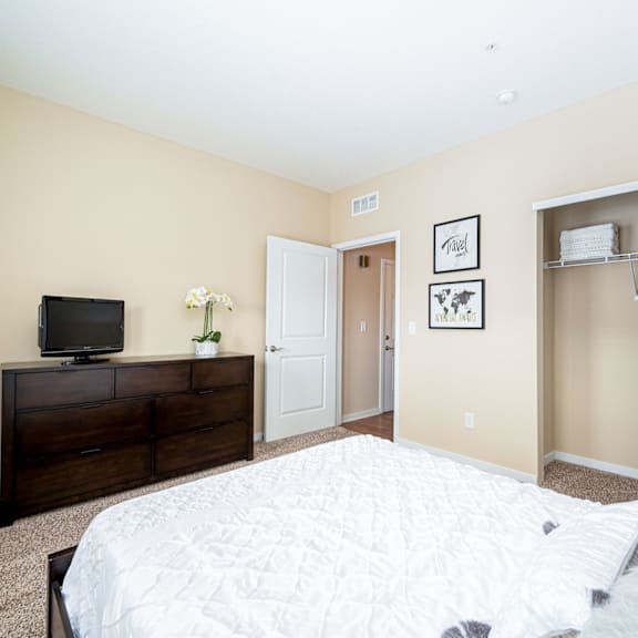 a bedroom with a large bed and a tv