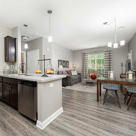 an open kitchen and living room with a table and chairs