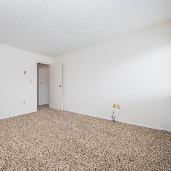 a room with carpeted floor and white walls.