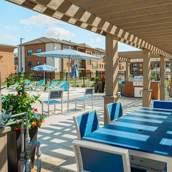a covered patio with tables and chairs and umbrellas