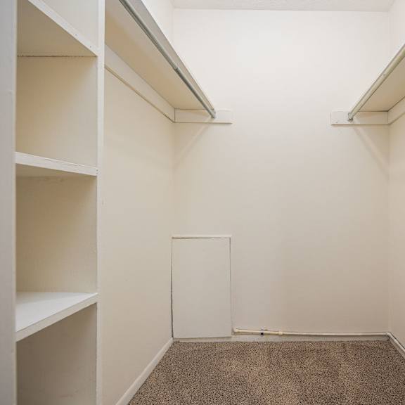 a white room with a carpeted floor and white walls.