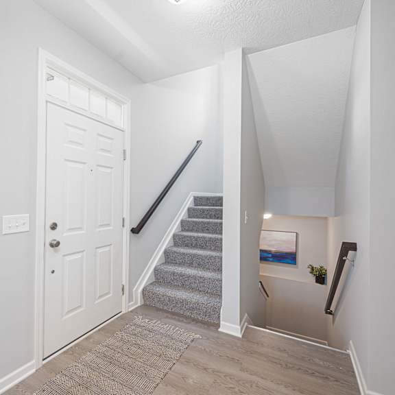 the entryway of liberty reserve with stairs and a white door