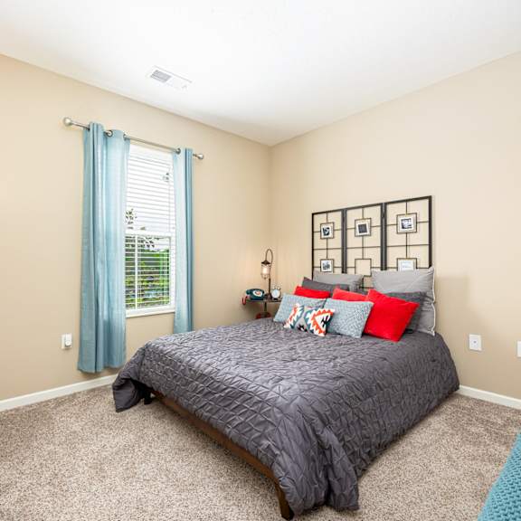 a bedroom with a bed and a window