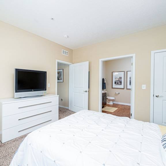 a bedroom with a bed and a television
