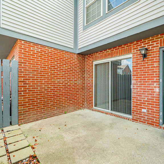 the entrance to a brick building with a green door