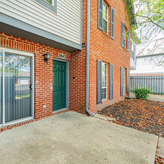 the entrance to a brick building with a green door