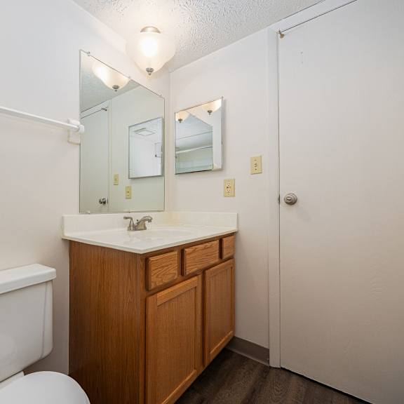 a white toilet sits next to a sink in a small bathroom.