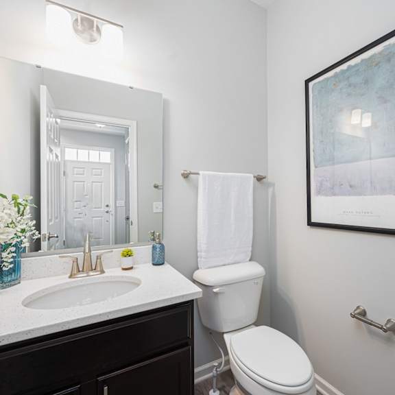 a bathroom with a toilet and a sink and a mirror