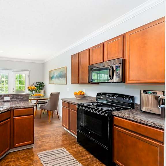 a kitchen with wooden cabinets and a black stove top oven.