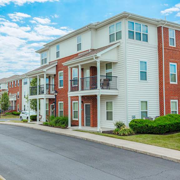 an empty street in front of an apartment building