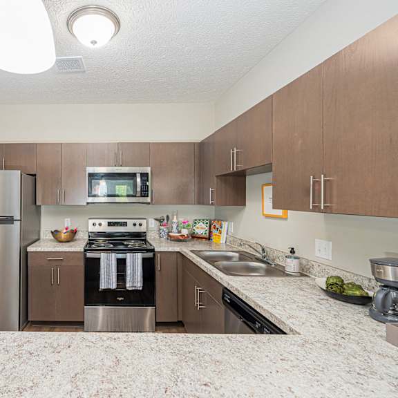 a kitchen with stainless steel appliances and granite counter tops